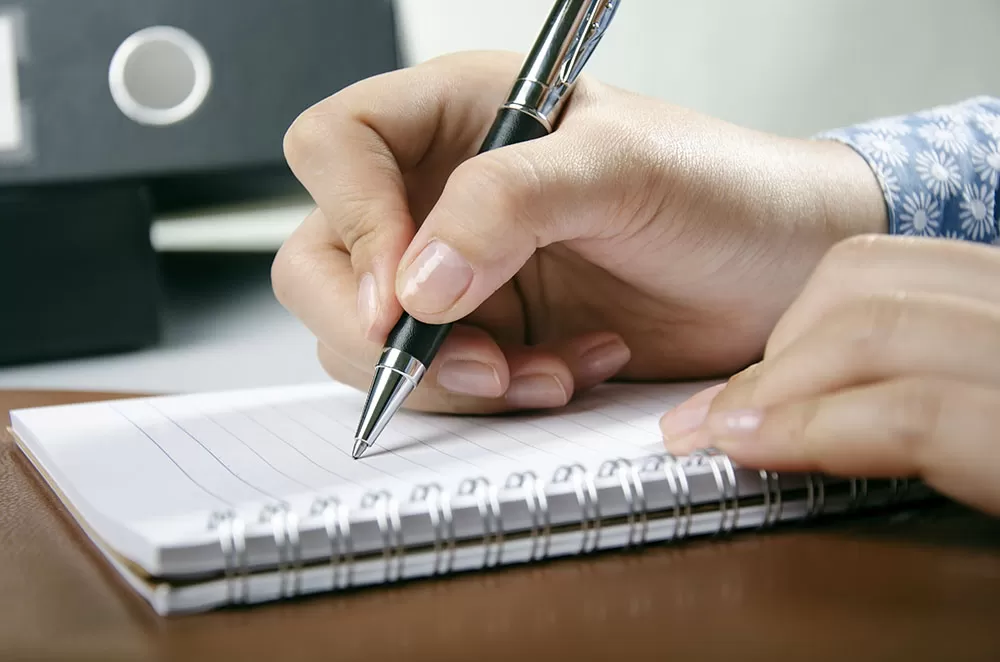 Woman Making a List for Home Remodeling Project