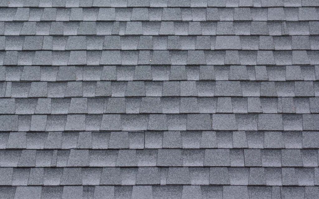 Asphalt shingles being installed on a residential roof.